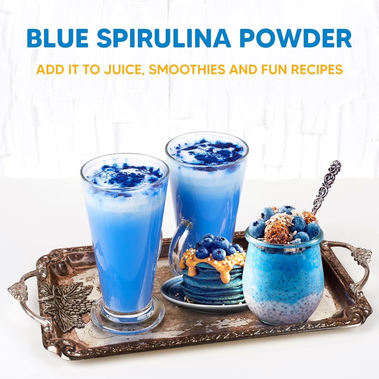 Blue spirulina powder being added to a smoothie