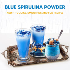 Blue spirulina powder being added to a smoothie