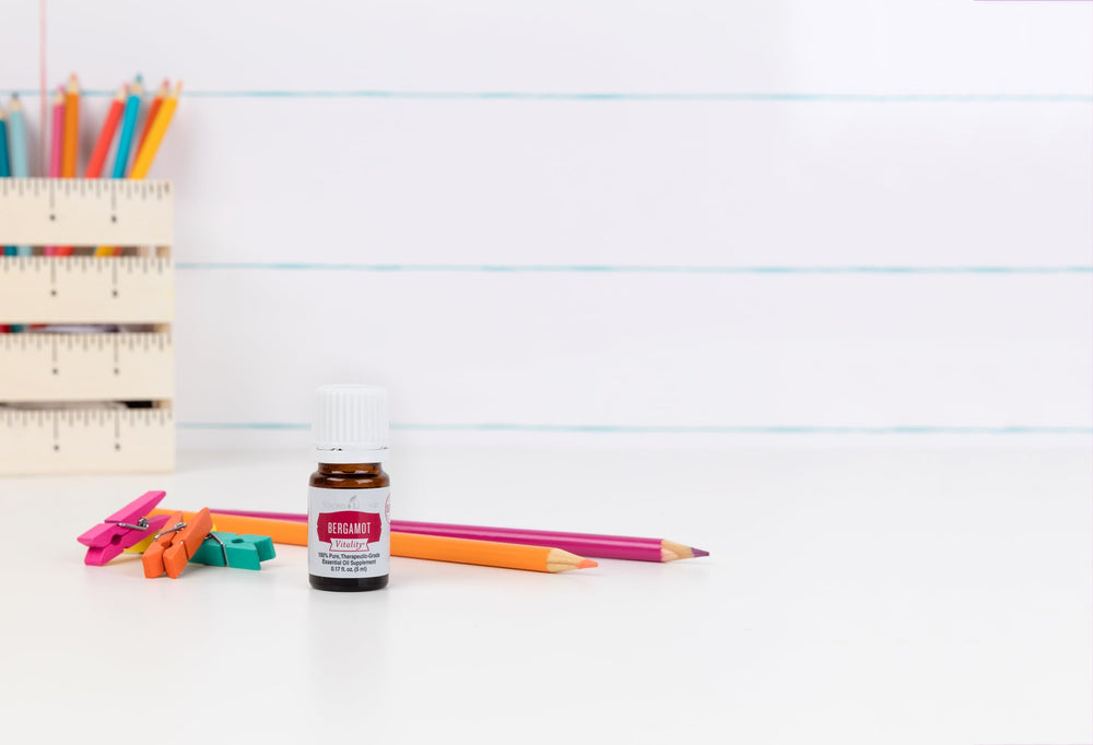 Young Living Bergamot Vitality bottle pouring reveals a clean, uplifting citrus infusion.