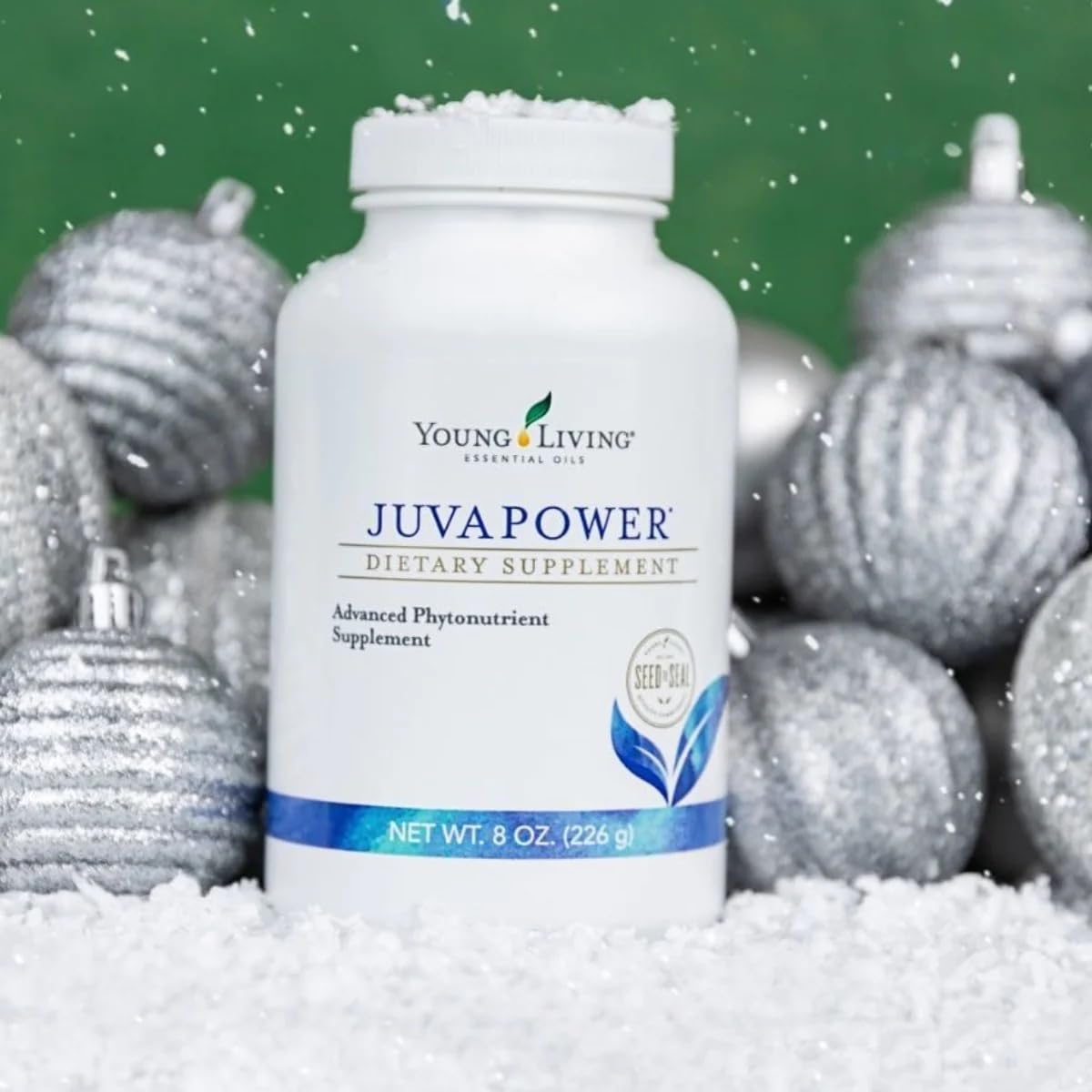 Young Living JuvaPower scoop adding powder to smoothie for antioxidant support.