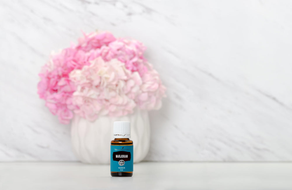Young Living Marjoram herbal aroma in a soft focus setting for natural relaxation