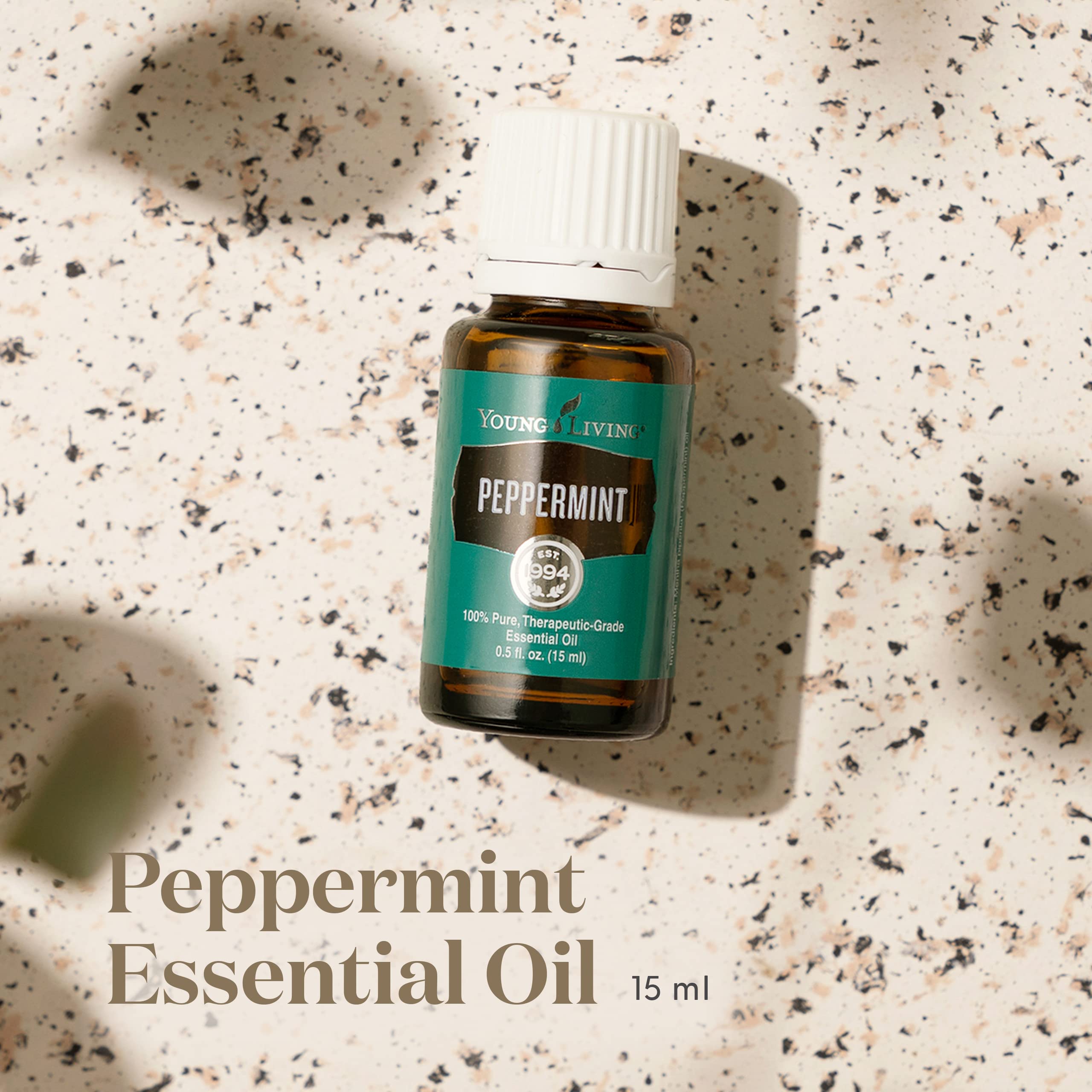 Close-up of Peppermint Essential Oil bottle showing purity
