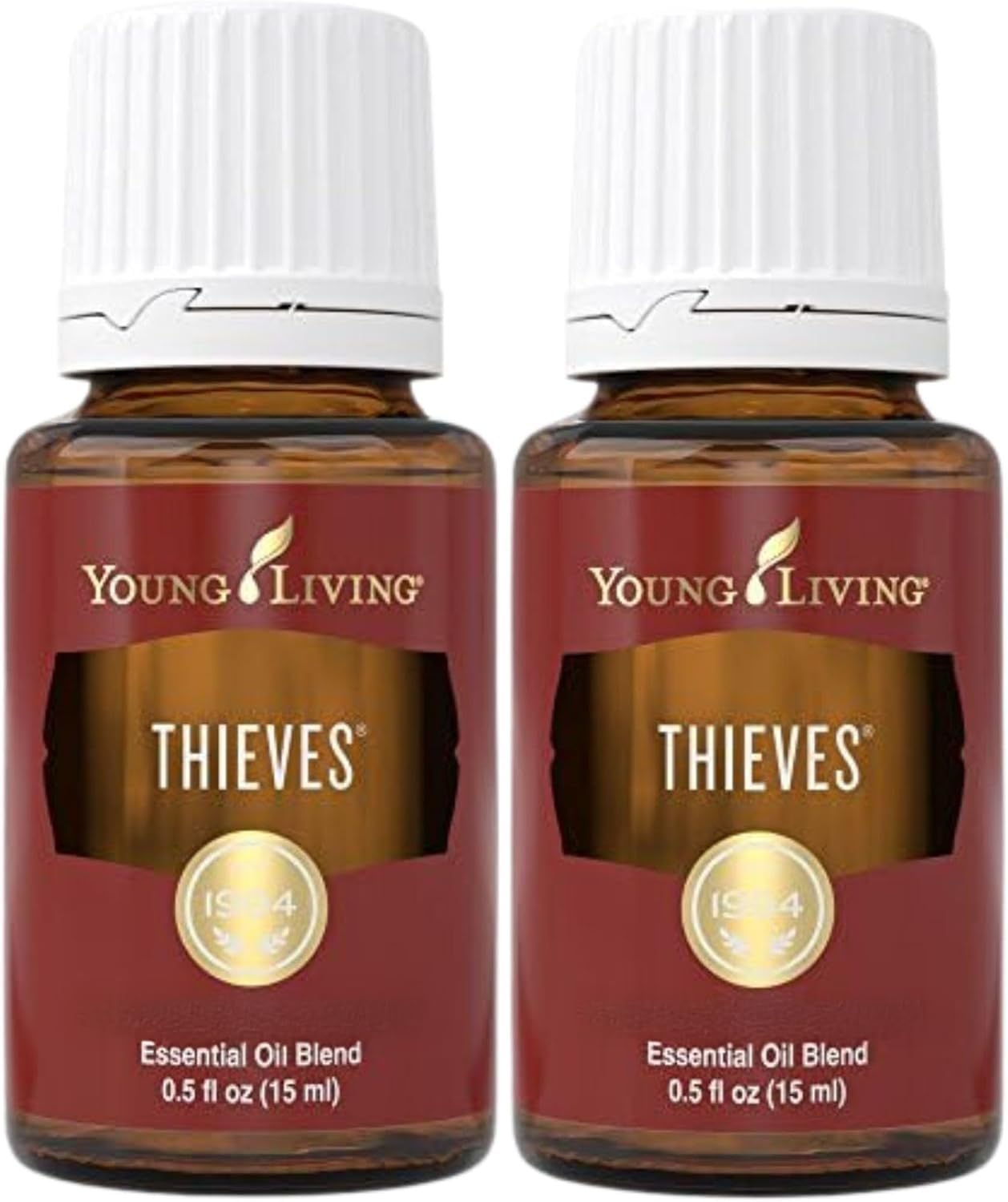 Two 15ml bottles of Young Living Thieves essential oil blend with rosemary and eucalyptus