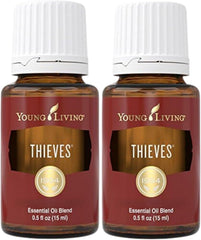 Two 15ml bottles of Young Living Thieves essential oil blend with rosemary and eucalyptus