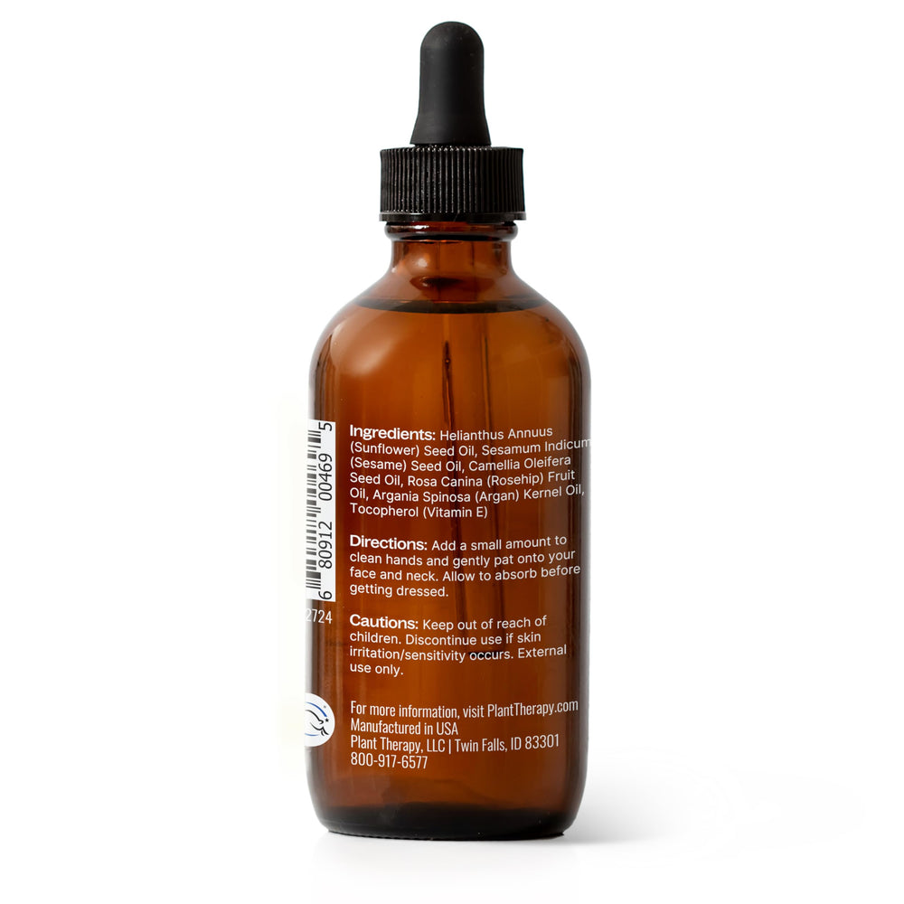 Hands applying Younger Glo Carrier Oil Blend to the face
