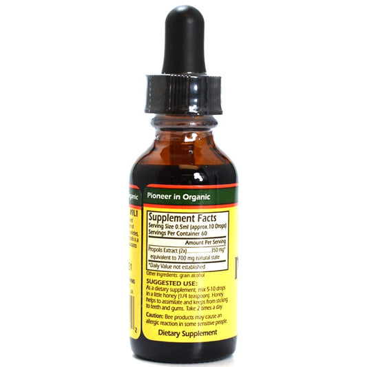 Propolis liquid drops being added to honey