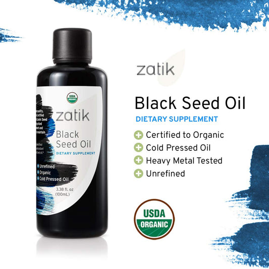 Close-up of cold-pressed black seed oil pouring from the bottle