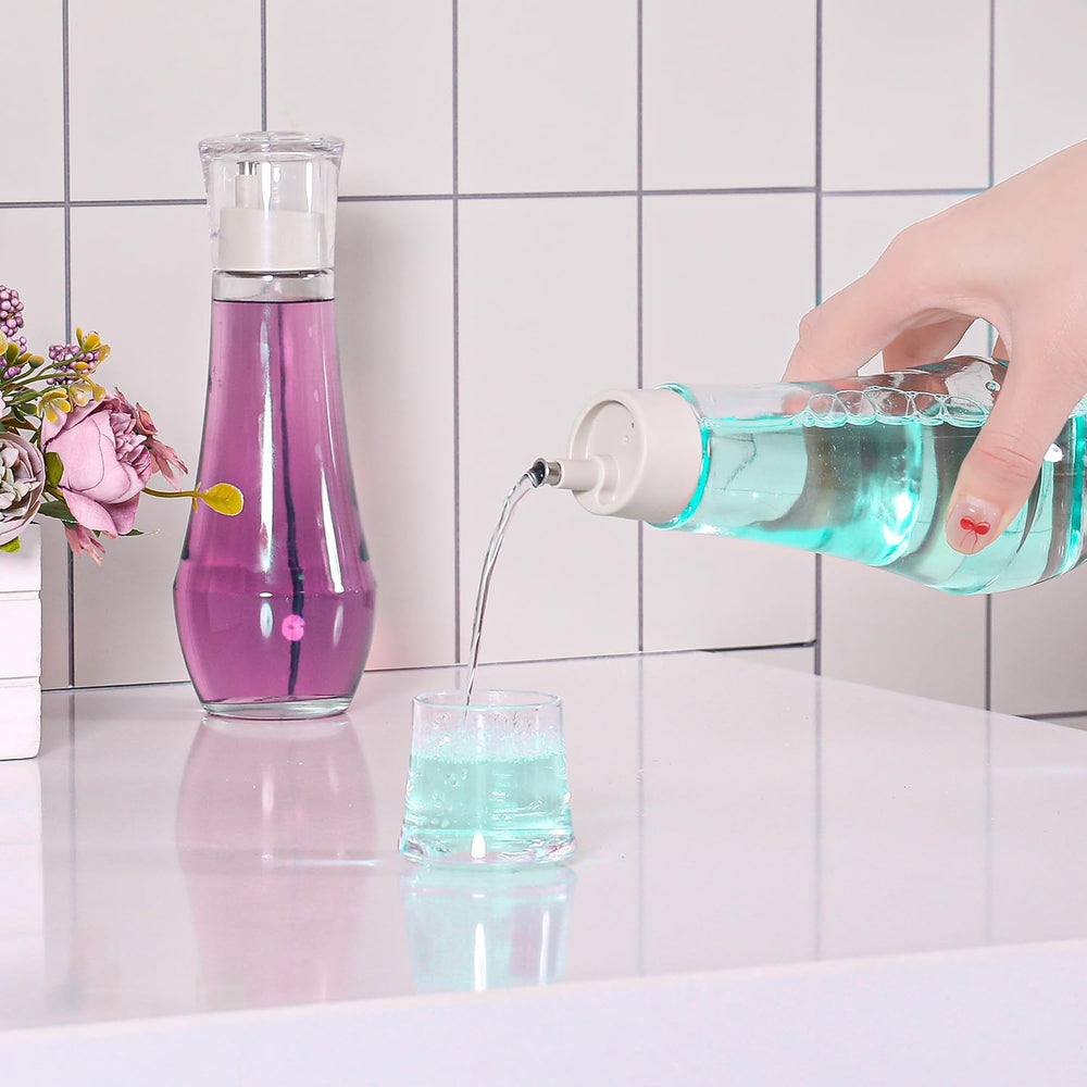 Close-up of glass bottle with cap and built-in cup