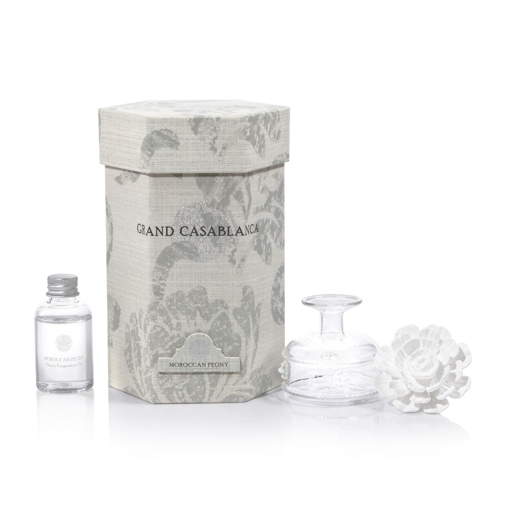 Close-up of glass oil container inside porcelain diffuser