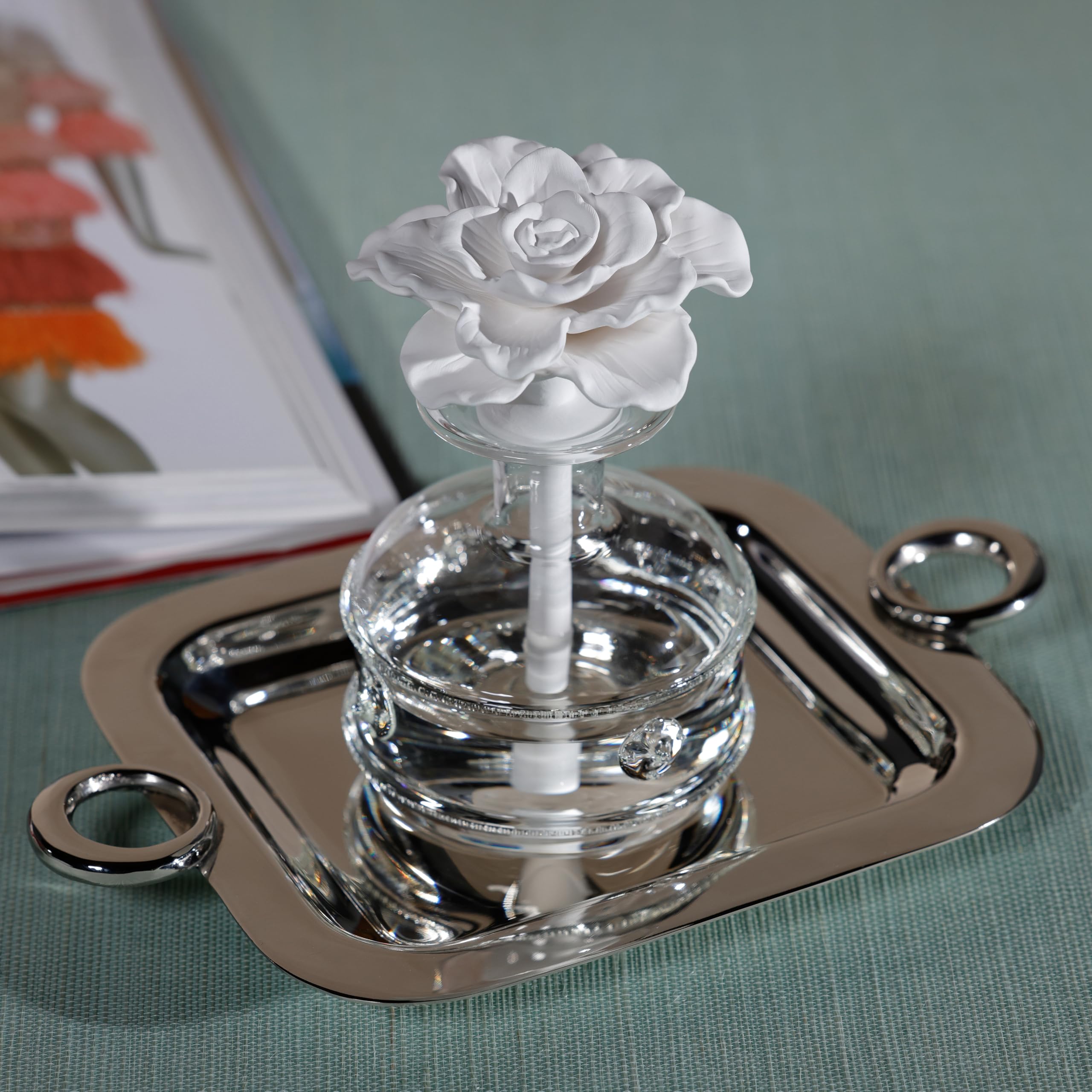 Close-up of the glass bottle and porcelain flower diffuser